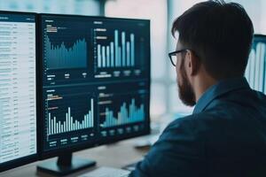 A man analyzes data on multiple screens, showcasing graphs and charts that represent financial or analytical information. photo
