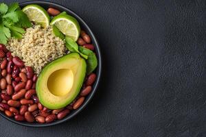 Plant-based ethics concept. A vibrant bowl features quinoa, avocado, red beans, lime, and fresh herbs, creating a healthy and colorful meal option. photo
