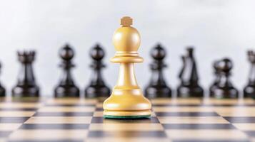 Planning risk and strategic growth concept. Golden chess piece in focus with black pieces blurred in the background on a checkered board. photo