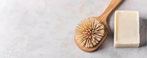 Zero waste lifestyle with DIY concept. wooden brush and a bar of soap on a textured surface. photo