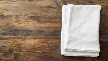 Zero waste lifestyle with DIY concept. Folded white napkins on a rustic wooden table surface. photo