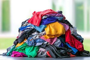 A colorful pile of assorted clothing items, showcasing various textures and styles, set against a blurred background. photo
