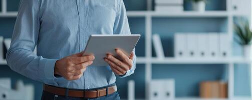 psychology of brand identity corporate concept. A person holding a tablet in a modern office with bookshelves in the background. photo