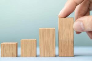 Determination of entrepreneurship growth mindset concept. Wooden blocks represent growth and progress, with a hand adjusting the largest block. photo