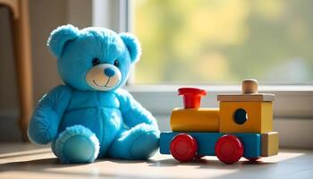Blue teddy bear beside a colorful wooden toy train on a tiled floor near a window with soft afternoon light photo