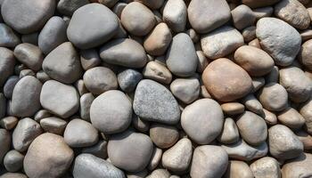 Wide angle smooth stone texture background showcasing a blend of smooth river stones, creating an organic and harmonious pattern photo