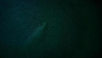 Aged dark green leather texture with deep creases and a matte finish in a dimly lit setting photo
