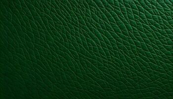 Textured synthetic leather background in a deep forest green, highlighting the natural wave like patterns and variations in surface texture photo