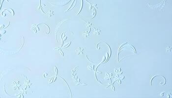 Vertical angle of a decorative plaster texture background in a soft pastel blue, with a slight sheen reflecting overhead light, showcasing smooth curves and delicate floral patterns photo