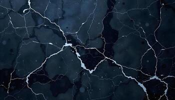 Dark marble texture with white veins and cracks, creating a bold, natural pattern photo