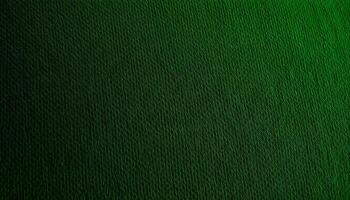 Synthetic fabric texture background showcasing a textured green upholstery fabric with visible fibers and a rich, deep color, accentuated by soft lighting photo