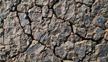Rough stone texture in gray and brown with intricate natural imperfections photo