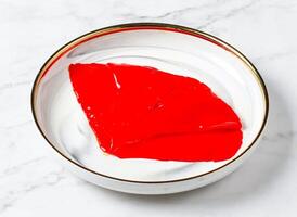 Squid with red sauce served in plate isolated on marble background side view of singapore food photo