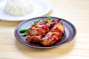 Barbecued Pork with Rice served in plate isolated on table side view of Hong Kong food photo