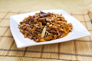 Fried Beef Noodles with Swiss Sauce served in plate isolated on table side view of Hong Kong food photo