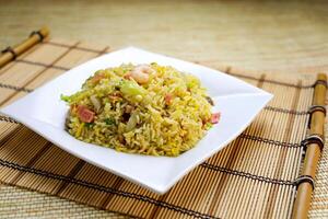 Yang Chow Fried Rice with Shrimp, ham, vegetables, and egg served in plate isolated on table side view of Hong Kong food photo