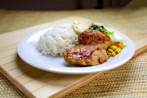 Scallion Chicken Chop with Rice, Egg Omelette and sou sauce served in plate isolated on table closeup side view of Hong Kong food photo