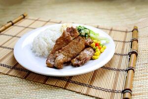 Scallion Pork Chop with Rice, Egg Omelette and sou sauce served in plate isolated on table closeup side view of Hong Kong food photo