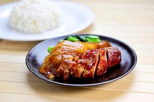 Roasted Duck Meat Rice served in plate isolated on table closeup side view of Hong Kong food photo