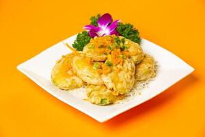 Golden crispy Jade Melon served in plate isolated on orange background side view of hong kong food photo