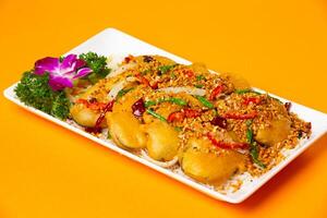 crispy Typhoon Shelter Eggplant served in plate isolated on orange background side view of hong kong food photo