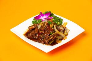 Beef Ribs Black pepper sauce with onion served in plate isolated on orange background side view of hong kong food photo