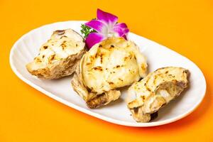 Grilled Hiroshima Oysters with Cheese served in plate isolated on orange background side view of hong kong food photo