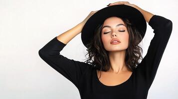 Stylish Female Model in Black Attire with Hat and Cheerful Expression photo