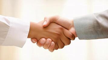 Two people shaking hands over a white background photo