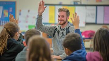 A man in a classroom raising his hands photo