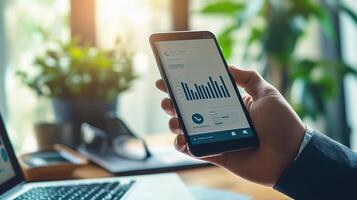 Businessman using smartphone to check financial data photo
