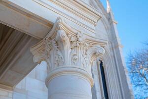 architectural detail of a gothic cathedral, capital of a column in the corinthian style photo