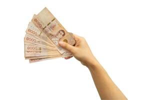 Asian woman holding Thai baht banknote money in hand isolated on whtie background with clipping path. photo