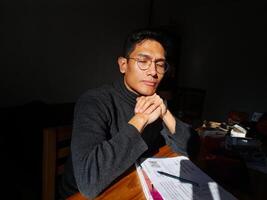 man with eyes closed thinking about his new projects photo