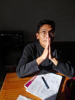 man praying with open eyes looking up with devotion photo