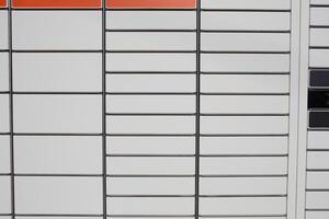 Modern parcel locker with closed compartments. Metal construction for convenient storage and package pickup. Concept of online shopping, automated delivery, and self-service. photo