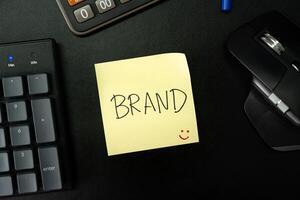 BRAND text with sticky note on keyboard. Build your Brand. Brand building, success, business. photo
