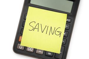 SAVING text with sticky note on calculator. financial concept. Saving money concept. Retirement concept. photo