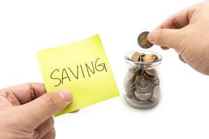 Saving money concept with Saving text on sticky note. Happy to placing a coin into a jar.Commitment to achieving financial goals. isolated on white background. photo