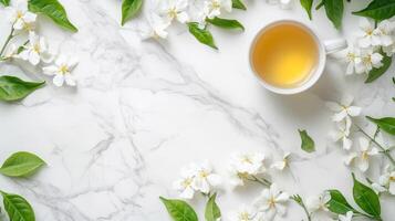 White flowers and tea cup on marble background photo