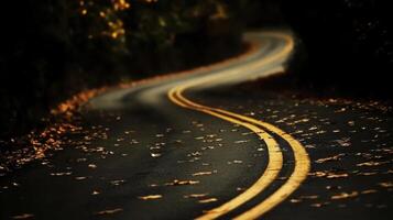 A winding road with yellow lines in the middle photo