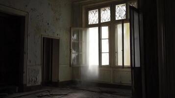 An empty room with a window and a light coming through photo