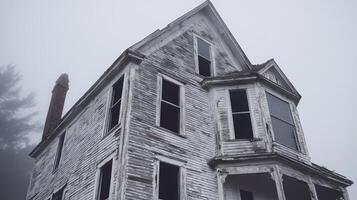 An old abandoned house in the fog photo