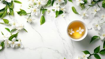 White flowers and tea cup on marble background photo