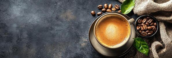 Coffee cup and beans on dark background. Top view with copy space photo