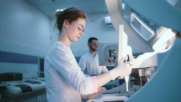 Scientists use lab equipment for an experiment, working with test tubes and samples. Concept scientific research and experiments using cutting-edge technology in the laboratory video
