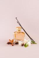A chic bottle of perfume with a gold cap on a beige background with vanilla sticks, cinnamon, vanilla flowers. vertical view. A blank bottle mockup. photo