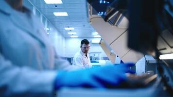 Scientists analyzes a blue liquid in a laboratory. Concept of research using cutting-edge technology to analyze chemical substances video