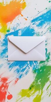 Delicate and artistic flat lay with empty white envelope on colorful abstract background for creative invitations photo