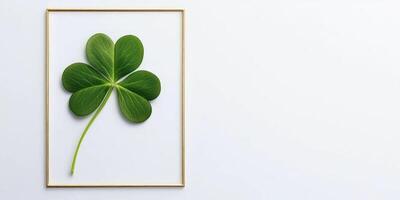 Minimalist St. Patricks day design featuring four leaf clover in gold frame photo